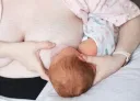 madre lactando con bebé en posición the agarre en rugby